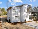 Modern home with gray siding, a sloped roof, and freshly mulched landscaping at 100 Farris Ct, Raleigh, NC 27610