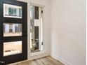 Bright entryway with wood floors, a modern door with windows, and neutral wall colors at 1521 Havenmont Ct, Raleigh, NC 27608