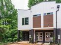 Modern townhome featuring brick accents, a single-car garage, and contemporary design elements at 1521 Havenmont Ct, Raleigh, NC 27608