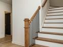 Elegant staircase with wood treads and a black metal railing adds a touch of sophistication at 1521 Havenmont Ct, Raleigh, NC 27608