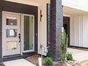 Inviting entrance with a stylish door, brick pillar, and manicured landscaping for a welcoming appeal at 1523 Havenmont Ct, Raleigh, NC 27608