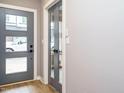 Modern entryway boasting wood flooring, a stylish front door, and gray interior doors at 1525 Havenmont Ct, Raleigh, NC 27608