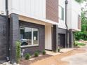 Townhouse exterior displaying a brick facade, modern design, and newly landscaped front yard at 1525 Havenmont Ct, Raleigh, NC 27608