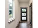 Clean, modern entryway with a black door and hardwood flooring at 1527 Havenmont Ct, Raleigh, NC 27608