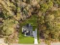 Aerial view showcasing the home, surrounding trees, and expansive green lawn at 143 Hook Dr # 23, Fuquay Varina, NC 27526