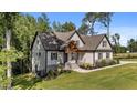 This beautiful home has an attached garage, landscaping, and stone accents at 143 Hook Dr # 23, Fuquay Varina, NC 27526
