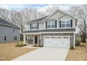 Beautiful two-story home with gray siding, black shutters, and a spacious two-car garage at 138 New Twin Branch Ct, Smithfield, NC 27577