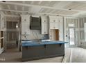 New kitchen with white cabinets and gray island at 95 Colonial Trail Ct, Pittsboro, NC 27312