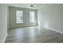 Light-filled bedroom boasts neutral walls, wood floors, recessed lights, and large windows for natural light at 492 Traditions Grande Blvd # 26, Wake Forest, NC 27587