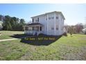 Charming two-story home with a welcoming porch, showcasing its inviting facade and ample natural light at 2913 Wadsworth Ave, Durham, NC 27707