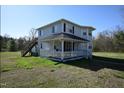 Two-story home featuring a covered porch and exterior staircase access to the second floor at 2913 Wadsworth Ave, Durham, NC 27707