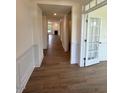 Long hallway featuring hardwood flooring and bright white trim at 103 Sage Ln # 009, Four Oaks, NC 27524