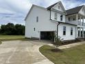 Spacious two-story house featuring attached garage, concrete driveway, and a lush green lawn at 123 Sage Ln # 010, Four Oaks, NC 27524