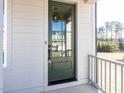 Green front door with glass panels and a modern design at 6059 Scalybark Road, Durham, NC 27712