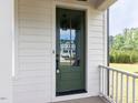 Beautiful green front door with glass panels for natural light at 6059 Scalybark Road, Durham, NC 27712