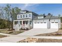 Beautiful two-story home with a covered front porch and an attached garage at 6060 Scalybark Rd, Durham, NC 27712