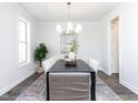 Bright dining room with a dark wood table and chandelier at 6063 Scalybark Road, Durham, NC 27712