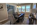 The dining room features ample sunlight from large windows and stylish decor at 234 Crystal Springs Way, Benson, NC 27504