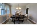 An inviting dining room features a stylish table, chandelier, and windows at 234 Crystal Springs Way, Benson, NC 27504