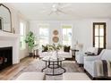 Bright living room with fireplace, plush seating, and large windows offering ample natural light at 30 Imperial Oaks Ct, Youngsville, NC 27596