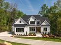 Beautiful two-story home featuring a painted brick exterior and pristine landscaping at 122 W Beech Slope Ct, Chapel Hill, NC 27517