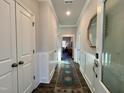 Bright hallway with wood floors, coat closet, and decorative rug at 141 Beacon Hill Rd # 13, Lillington, NC 27546