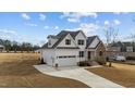 Beautiful new construction features a stone and white accent exterior, large garage and well manicured lawn at 125 Cotton Fields Ln # 26, Fuquay Varina, NC 27526