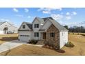 Beautiful new construction features a stone and white accent exterior, large garage and well manicured lawn at 125 Cotton Fields Ln # 26, Fuquay Varina, NC 27526