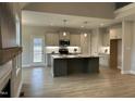 Modern kitchen features stainless appliances, a large central island, and ample cabinet space at 27 Prency Ln, Middlesex, NC 27557