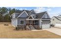 Charming two-story home featuring a stylish gray exterior, stone accents, and an inviting front porch at 262 Hook Dr # 12, Fuquay Varina, NC 27526