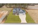 Stunning two-story home with a three-car garage, a blue facade, and a long driveway at 262 Hook Dr # 12, Fuquay Varina, NC 27526