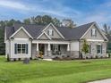 Beautiful single-story home with a stone facade, shutters, and a well-manicured lawn at 100 Old Garden Ln, Youngsville, NC 27596