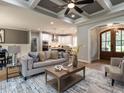 Cozy living room with coffered ceilings, fireplace and arched doorways at 100 Old Garden Ln, Youngsville, NC 27596