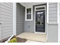 A black front door with silver hardware is surrounded by gray siding and trim at 125 Sugar Run Dr # 26, Fuquay Varina, NC 27526