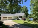 Charming single-story home features a two-car garage, well-manicured lawn, and a serene lake view at 3309 Westcott Cir, Sanford, NC 27330