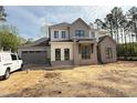 New two story home with gray and white accents, black window frames, and attached two car garage at 2633 Trifle Ln, Wake Forest, NC 27587