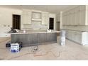 Modern kitchen featuring white cabinets, a large island with gray trim, and stainless steel appliances at 2633 Trifle Ln, Wake Forest, NC 27587