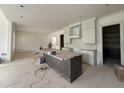 Modern kitchen featuring white cabinets, a large island with gray trim, and stainless steel appliances at 2633 Trifle Ln, Wake Forest, NC 27587