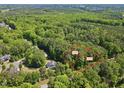 The property has a lush, wooded landscape, perfect for building a secluded home in a natural setting at 2332 Windy Woods Dr, Raleigh, NC 27607