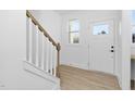 Bright entryway with light wood staircase and wood-look flooring at 331 Roxboro St, Haw River, NC 27258