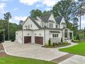 Stunning new home with a three-car garage, stone accents, and pristine landscaping on a verdant lawn at 1621 Legacy Ridge Ln, Wake Forest, NC 27587