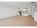Open floor plan with hardwood floors throughout the living room and kitchen area at 814 Barlow Dr, Knightdale, NC 27545