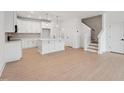 Spacious living room with hardwood floors adjacent to a kitchen with island at 814 Barlow Dr, Knightdale, NC 27545