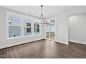 Bright dining area features large windows, stylish chandelier and a sliding door to the deck at 1505 Patchings Ln, Knightdale, NC 27545