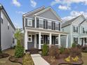 Inviting two-story home with a covered front porch and well-manicured landscaping at 1505 Patchings Ln, Knightdale, NC 27545