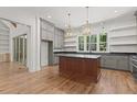 Beautiful kitchen with hardwood floors, center island, stainless steel appliances, and view of the backyard at 3691 Graham Sherron Rd, Wake Forest, NC 27587