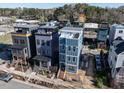 Modern three-story home boasts a rooftop terrace and contemporary design elements in a developing community at 618 Velma Hopkins Ln, Raleigh, NC 27603