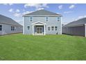 Spacious backyard with a large grassy area and patio at 292 Chestnut Oak Ln, Lillington, NC 27546