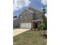 Charming brick two-story home features a large garage and well-manicured front yard at 401 Winding Creek Dr, Lillington, NC 27546