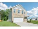 Attractive home featuring a two-car garage, well-maintained lawn, and classic architectural details at 401 Winding Creek Dr, Lillington, NC 27546